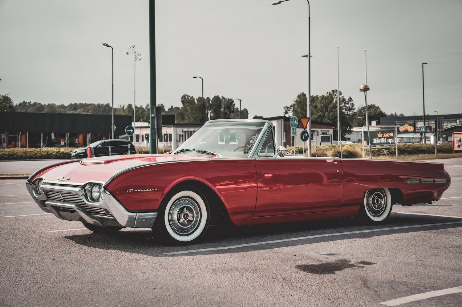 Custom lowrider featuring classic whitewall tires and vintage automotive aesthetics